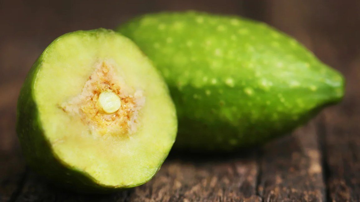 close up image of sliced haritaki fruit with seeds