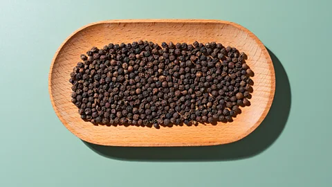 Getty Images A wooden dish containing black peppercorns (Credit: Getty Images)