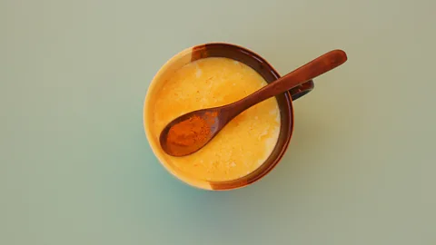 Getty Images Tiny fat droplets in milk make an ideal transport system for the nutrients in turmeric (Credit: Getty Images)