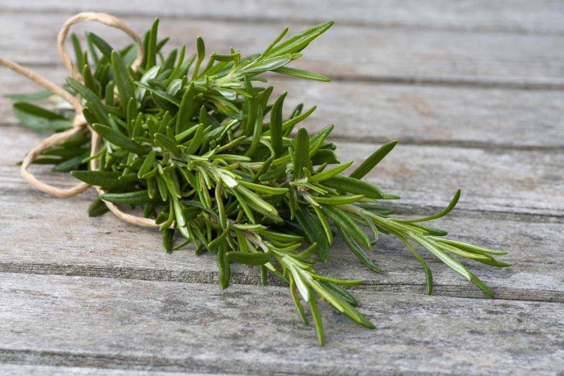 rosemary-leaves-bound-in-rope-on-wooden-table