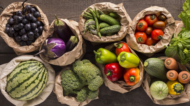 Fruits and vegetables in brown baskets on wooden table