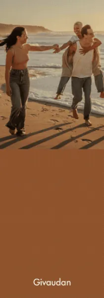 Three friends enjoying a playful moment on a sunlit beach at sunset, with ocean waves behind them and the Givaudan logo below