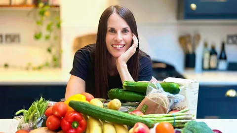BBC/ Stephen Parker Melissa Hogenboom stands with a pile of fresh produce in front of her